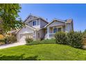 Inviting home showcasing a well-kept lawn, a covered front porch, and classic architectural details at 11357 Iola St, Commerce City, CO 80640