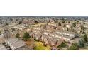 An aerial view showcases a thriving neighborhood with tree-lined streets and well-maintained townhomes at 2925 S Vaughn Way, Aurora, CO 80014