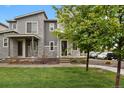 Beautiful two-story home with stone and siding accents, and a well-kept lawn and garden at 23615 E 5Th Pl, Aurora, CO 80018