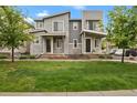 Stylish two-story home boasts modern design, manicured lawn, and welcoming entrance at 23615 E 5Th Pl, Aurora, CO 80018