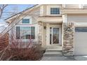 Close-up of the home's entrance, highlighting the brickwork and well-lit entryway at 5857 S Zante Cir, Aurora, CO 80015