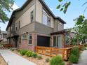 Exterior view of home with combination brick and siding, showcasing a small fenced-in patio at 11719 W 45Th Pl, Wheat Ridge, CO 80033