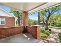 Covered front porch with brick supports and a view of the street and mature trees, creating a welcoming outdoor space at 1260 S Emerson St, Denver, CO 80210