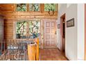 The entryway features stained glass windows, terra cotta floors, and natural wood accents at 4560 Hilltop Rd, Evergreen, CO 80439
