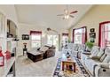 Bright living room with plush seating, vaulted ceilings, and a cozy fireplace at 9046 Sandpiper Dr, Frederick, CO 80504
