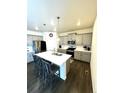 Bright kitchen with an island, stainless steel appliances and gray cabinets at 7435 E 159Th Pl, Thornton, CO 80602