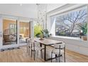 Bright dining room featuring a modern table with stylish chairs and a window overlooking greenery at 1801 W 33Rd Ave, Denver, CO 80211