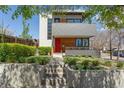 Modern home features layered landscaping, concrete retaining walls and stairway to the red front door at 1801 W 33Rd Ave, Denver, CO 80211