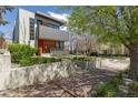 Modern home features layered landscaping, concrete retaining walls and stairway to the red front door at 1801 W 33Rd Ave, Denver, CO 80211