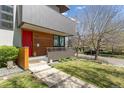 Modern home showing covered front porch with stone walkway, wood accents and well maintained lawn at 1801 W 33Rd Ave, Denver, CO 80211