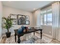 Bright study featuring a large window, patterned rug, and contemporary decor at 4114 Estrella St, Brighton, CO 80601
