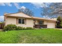 Inviting single-story home with green lawn and mature trees on a bright, sunny day at 726 Mobile St, Aurora, CO 80011