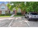 Townhouse exterior with assigned parking and mature trees in a well-maintained community at 9679 W Chatfield Ave # C, Littleton, CO 80128