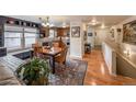 The dining area features a wooden table set, built-in bench seating, and kitchen view at 13642 Wrangler Way, Mead, CO 80542