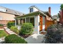 Home entrance featuring a modern wood door, manicured landscaping, and natural stone pathway at 4729 W 32Nd Ave, Denver, CO 80212