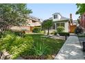 A verdant front yard is beautifully landscaped with lush grass and garden area at 4729 W 32Nd Ave, Denver, CO 80212