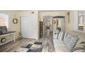 Inviting entryway with stylish decor, wood-look floors, and a welcome sign at 7390 Ute Hwy, Longmont, CO 80503