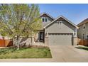 Charming two-story home with a well-manicured lawn and attached two-car garage at 7823 E 130Th Pl, Thornton, CO 80602