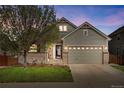 Charming two-story home with a well-maintained lawn and attached two-car garage at 7823 E 130Th Pl, Thornton, CO 80602