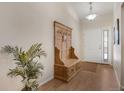 Bright foyer featuring hardwood floors, a decorative hall tree, and a welcoming ambiance at 7823 E 130Th Pl, Thornton, CO 80602