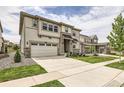 Inviting two-story home with a spacious driveway, lawn and attractive stone and siding accents at 3162 Grizzly Peak Dr, Broomfield, CO 80023