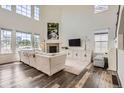 Bright living room with high ceilings, fireplace, lots of light and modern decor at 3162 Grizzly Peak Dr, Broomfield, CO 80023