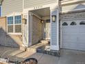 Covered front porch entry with brick columns and a double door at 23975 E Arizona Pl, Aurora, CO 80018