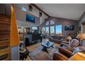Living room featuring high ceilings, a shark painting, and hardwood flooring at 11222 Conifer Mountain Rd, Conifer, CO 80433