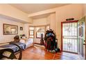 Inviting living room with hardwood floors, a bay window, and an open doorway at 5185 E Weaver Dr, Centennial, CO 80121