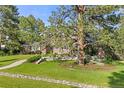 Traditional brick home nestled among mature trees and lush landscaping, creating a serene and inviting setting at 5428 Golden Currant Way, Parker, CO 80134
