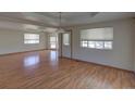 Spacious living room with hardwood floors, recessed ceilings, and lots of natural light at 233 Cherokee Ct, Brighton, CO 80603