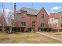 Charming brick two-story home with manicured lawn, slate roof and welcoming front entry at 945 Niagara St, Denver, CO 80220