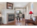 Open dining area features a fireplace, hardwood floors, natural light, and views to the living room at 129 N Irvington St, Aurora, CO 80018