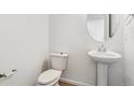 Bathroom featuring a pedestal sink and sleek fixtures at 9051 Telluride Ct, Commerce City, CO 80022