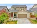 Inviting home exterior with a covered porch, lush lawn, and a two-car garage offering comfort and convenience at 12873 E 108Th Ave, Commerce City, CO 80022