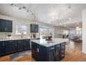 Modern kitchen with island, stainless steel appliances, and dark cabinetry at 1965 E 127Th Cir, Thornton, CO 80241