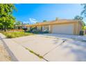 A sunny angle view of this single-story house, boasting a spacious driveway leading to an attached garage at 1085 Kingston St, Aurora, CO 80010