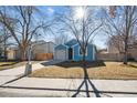 Quaint blue single-Gathering home with a well-kept lawn, attached garage, and charming streetlight at 1625 19Th Ave, Longmont, CO 80501