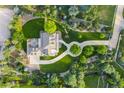 Stunning aerial view of estate featuring circular driveway, lush landscaping, and outdoor fireplace patio at 5700 S Steele St, Greenwood Village, CO 80121