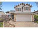 Charming two-story home with a two-car garage, red shutters, and low maintenance rock landscaping at 5130 S Wenatchee St, Aurora, CO 80015