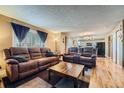 Comfortable living room featuring a spacious layout, modern flooring, and neutral color tones at 5130 S Wenatchee St, Aurora, CO 80015
