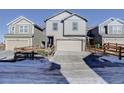 Two-story townhome with attached garage and small fenced yard at 28418 E 8Th Pl, Watkins, CO 80137