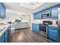 Open-concept kitchen with stainless steel appliances and views of the dining and living area at 1080 S Yampa St, Aurora, CO 80017