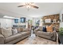 Inviting living room showcasing a fireplace, modern furniture, and seamless flow to the kitchen and dining area at 1080 S Yampa St, Aurora, CO 80017