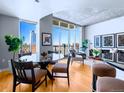 Open concept dining area with glass table and city views at 891 14Th St # 3704, Denver, CO 80202