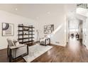 Bright living room with hardwood floors, plush armchairs, stylish decor, and an open doorway at 2038 S Columbine St, Denver, CO 80210