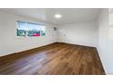 Bright living room with new hardwood floors, fresh white walls and ample natural light, perfect for entertaining guests at 1153 Sherman St, Longmont, CO 80501