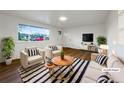 Bright living room with stylish decor, wood floors, large window, and comfortable seating arrangement at 1153 Sherman St, Longmont, CO 80501