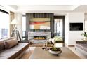 Elegant living room with a modern fireplace, stylish decor, comfortable seating, and access to a balcony at 1133 14Th St # 4150, Denver, CO 80202