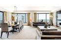 Spacious living room with large windows, city views, contemporary furniture, and a dining area at 1133 14Th St # 4150, Denver, CO 80202